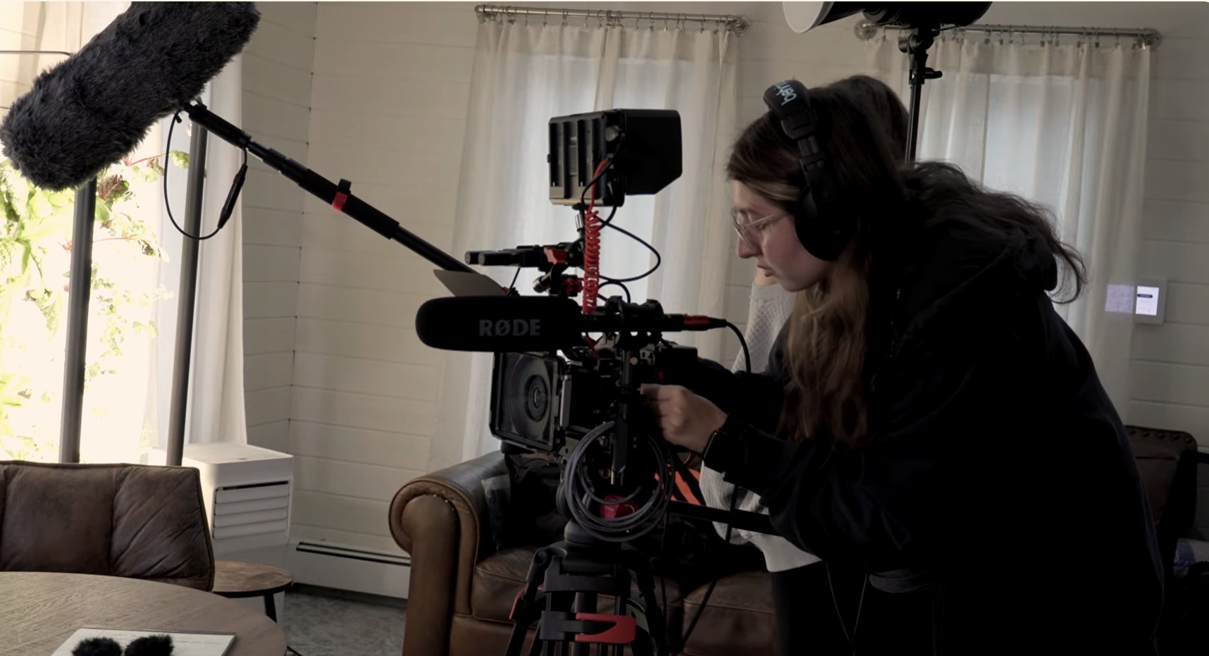 Camera operator adjusting a cinema rig during a Chrysalis interview shoot